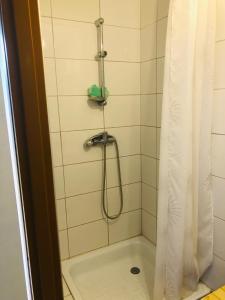 a bathroom with a shower with a shower curtain at Agroturystyka Mokre in Barkowice
