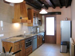 a kitchen with a sink and a refrigerator at Sagardikoetxea II in Oskotz