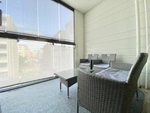 a room with chairs and a table and a window at City Home Finland Big Luxury Suite - Spacious Suite with Own SAUNA, One Bedroom and Furnished Balcony next to Train Station in Tampere
