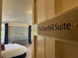 a hotel room with a sign that reads the international suite at The Randolph Hotel in Southwold