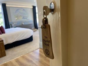 a sign on the door of a room with a bed at The Randolph Hotel in Southwold