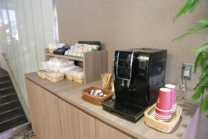 a counter with a coffee maker and baskets on it at Rose Stay Tokyo Shiba Park in Tokyo