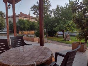 a patio with a table and chairs in a yard at Shale apartments and rooms in Gevgelija