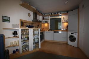 a kitchen with white cabinets and a washer and dryer at Ferienwohnung "Zum Böhler Leuchtturm" in Sankt Peter-Ording