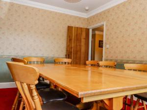 a conference room with a large wooden table and chairs at The Orchard in Rye