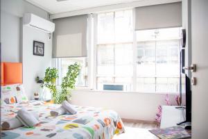 Postel nebo postele na pokoji v ubytování Ermou 18 Mosaics boutique apartment