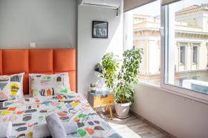 Postel nebo postele na pokoji v ubytování Ermou 18 Mosaics boutique apartment