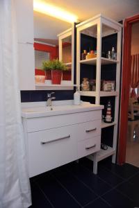 a bathroom with a white sink and a shelf at Dandy Villas Velanidia Sailor's House - Private Maisonette - Sea View in Velanídhia