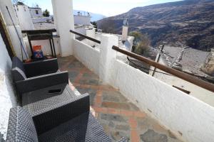 a balcony with stairs and a view of a mountain at Preciosa casa en capileira in Capileira