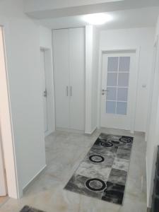 a white room with a rug on the floor at Apartment Ilidza-SK in Sarajevo +2 photos