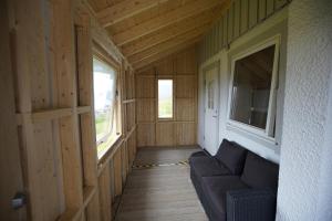 a hallway of a wooden house with a couch at Havøysund house with a beautiful view in Måsøy