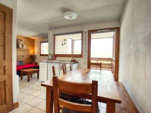 a kitchen and dining room with a table and chairs at Appartement Morillon 1100, 3 pièces, 7 personnes - FR-1-642-1 in Morillon