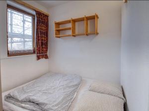 a small bedroom with a bed and a window at Appartement Morillon 1100, 2 pièces, 5 personnes - FR-1-642-31 in Morillon