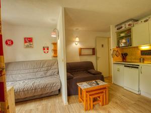 a small living room with a couch and a table at Appartement Morillon 1100, 2 pièces, 5 personnes - FR-1-642-45 in Morillon