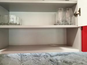 a cupboard with glasses sitting on top of it at В сърцето на Варна ви очаква прекрасен и просторен апартамент in Varna City