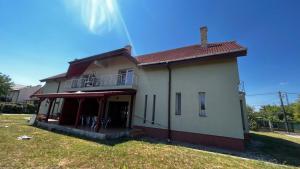 a house with a balcony on the side of it at Casa Vio in Timişoara