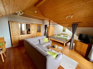 a living room with a couch and a bed at Ferienwohnung AlmLust in Hochrindl