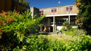 two people walking in front of a building at OSTAL Brest - Auberge de jeunesse du Moulin Blanc in Brest +13 photos