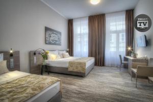 Posteľ alebo postele v izbe v ubytovaní Hotel Páv