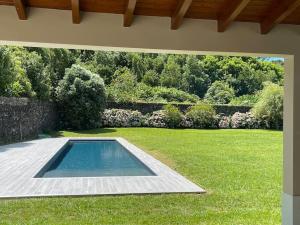a swimming pool in the middle of a yard at Azores Green Nature in Rabo de Peixe