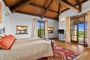 a bedroom with a large bed in a room with windows at Villa Adriana in Brajkovići +50 photos