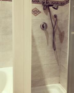 a shower with a shower head in a bathroom at Le Affinità Selettive in Turin