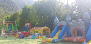 a childrens playground with a castle and slides at Bungalow at Lake Lugano in Porlezza