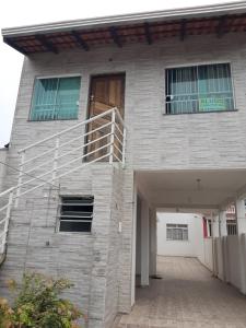 a building with a staircase on the side of it at Casa em Matinhos PR in Matinhos