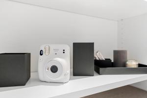 a camera sitting on a shelf with other items at VibeStudio 304 - Central - AC - Licensed - Parking Nearby in Vienna