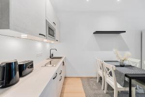 a kitchen with a table and a dining room at VibeStudio 304 - Central - AC - Licensed - Parking Nearby in Vienna
