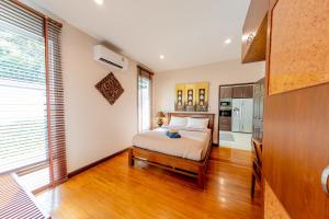 a bedroom with a bed and a kitchen at Hua Hin Horizon in Hua Hin