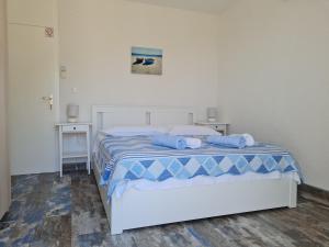 a bedroom with a bed with blue towels on it at Rooms Anđelka in Bol