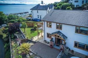 an aerial view of a white house with a roof at Bayview House - 4 Bedroom Luxurious Holiday Home - Saundersfoot in Saundersfoot