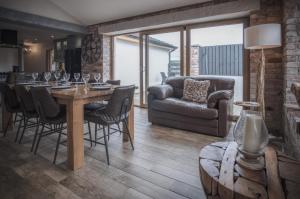 a living room with a table and chairs and a couch at Bayview House - 4 Bedroom Luxurious Holiday Home - Saundersfoot in Saundersfoot