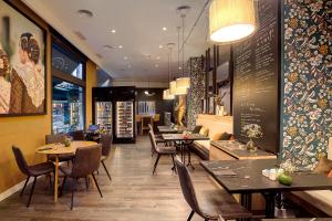 a restaurant with tables and chairs and a menu at Catalonia Excelsior in Valencia