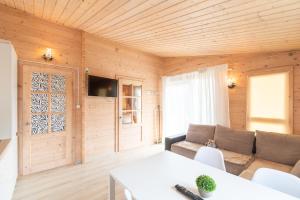 a living room with a couch and a table at Domki Marina Rowy in Rowy