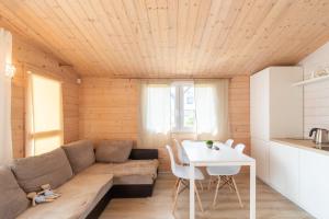 a living room with a couch and a table at Domki Marina Rowy in Rowy