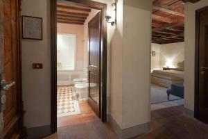 a room with a door open and a bed in it at Castello di Spaltenna Exclusive Resort & Spa in Gaiole in Chianti