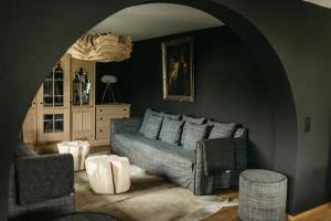 a living room with a couch and two chairs at Loretto in Oberstdorf