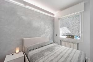 a bedroom with a bed and a window at Serendipity in Alassio