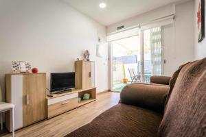 a living room with a couch and a television at Nuevo apartamento en bahia de mazarron a estrenar in Murcia