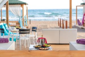 a table with a plate of food on a beach at Sentido Kamelya Selin Luxury Resort & SPA in Side