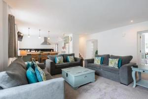 a living room with two couches and a table at Lovely 5-Bed House in Lundin Links coastal village in Lundin Links