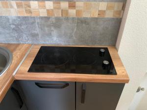 a stove top in a kitchen with a sink at Puro LakeSide in Struga