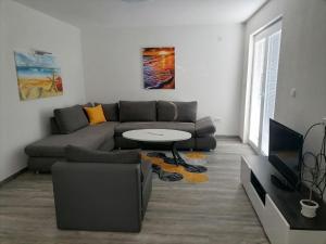 a living room with a couch and a table at Puro LakeSide in Struga +14 photos