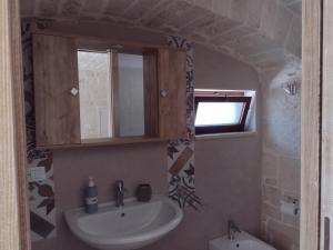 a bathroom with a sink and a mirror at La casa di pietra in Monopoli
