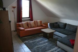 a living room with two couches and a table at Sunshine Apartment 5 in Nidda +1 photo