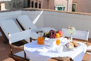 a table with a bowl of fruit and orange juice at Maiori Dream Rental in Maiori