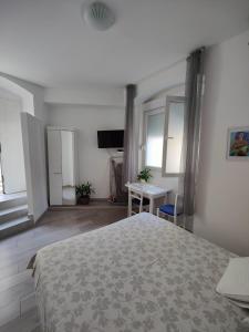 a bedroom with a bed and a desk and a television at Stipan Studio & Room in Split