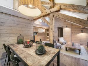 a dining room with a large wooden table and chairs at Superbe duplex central à Méribel pour 8 pers, proche pistes - FR-1-565-16 in Les Allues